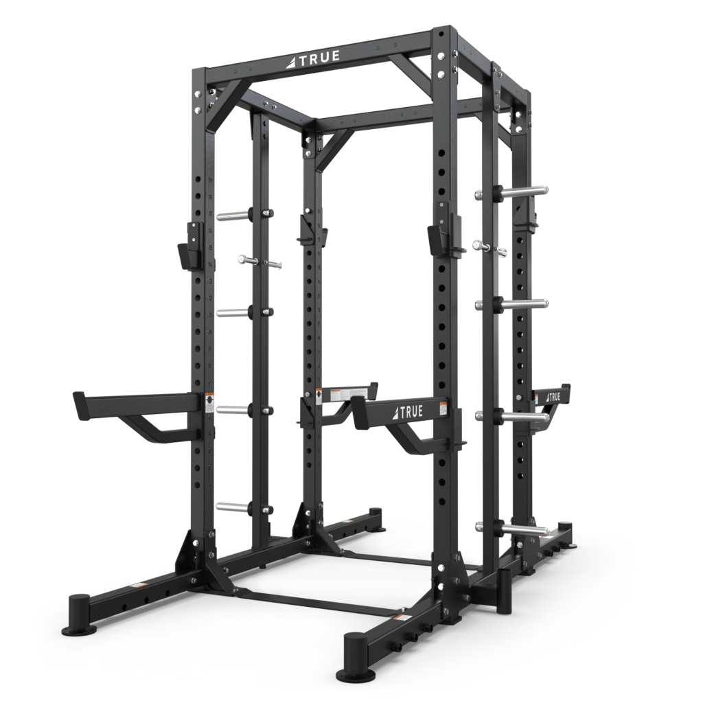 A black metal squat rack with adjustable safety bars, pull-up bar, and weight plate storage, designed for strength training and weightlifting, shown against a plain white background.