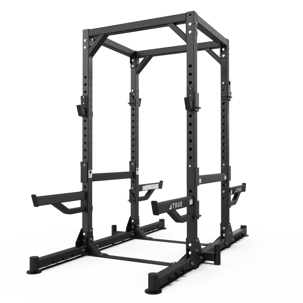A black metal power rack with adjustable safety bars and attachments, designed for weightlifting and strength training, isolated on a white background.