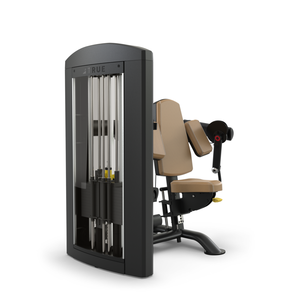 A beige and black gym machine designed for seated leg or hip exercises, featuring padded seats and backrest, adjustable arm, and a weight stack with guide rods enclosed in a metal frame.