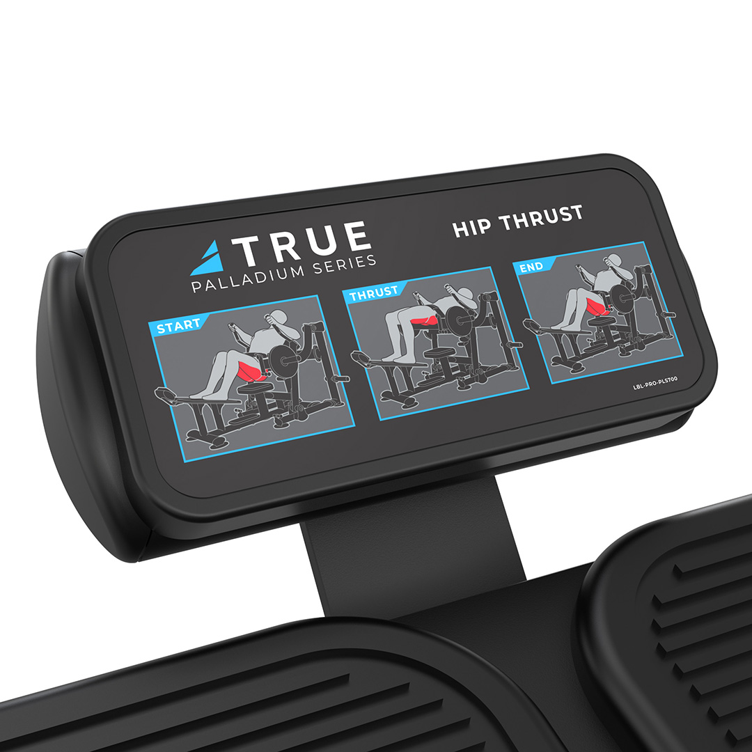 Close-up of a fitness machine display labeled TRUE Palladium Series Hip Thrust, showing illustrated instructions for hip thrust exercises in three steps: start, thrust, and end positions.