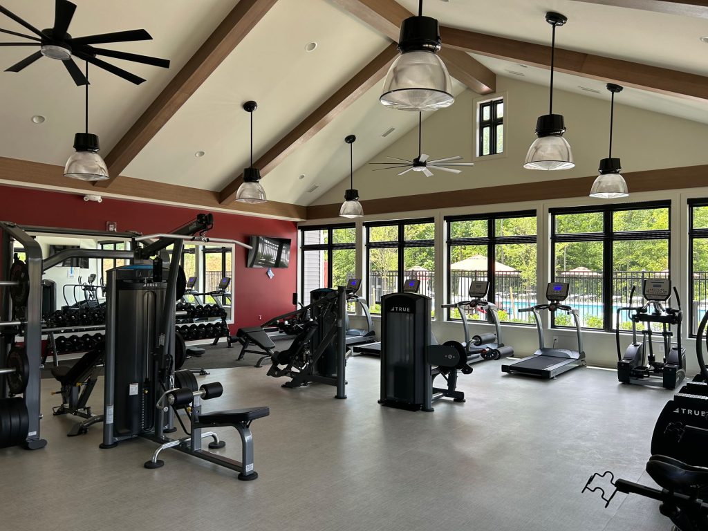 A large gym with many exercise equipment.