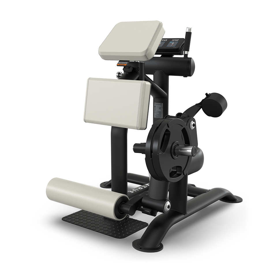 A black and silver gym machine with padded supports and a foot roller, designed for seated leg exercises, positioned on a black metal frame with a footplate.