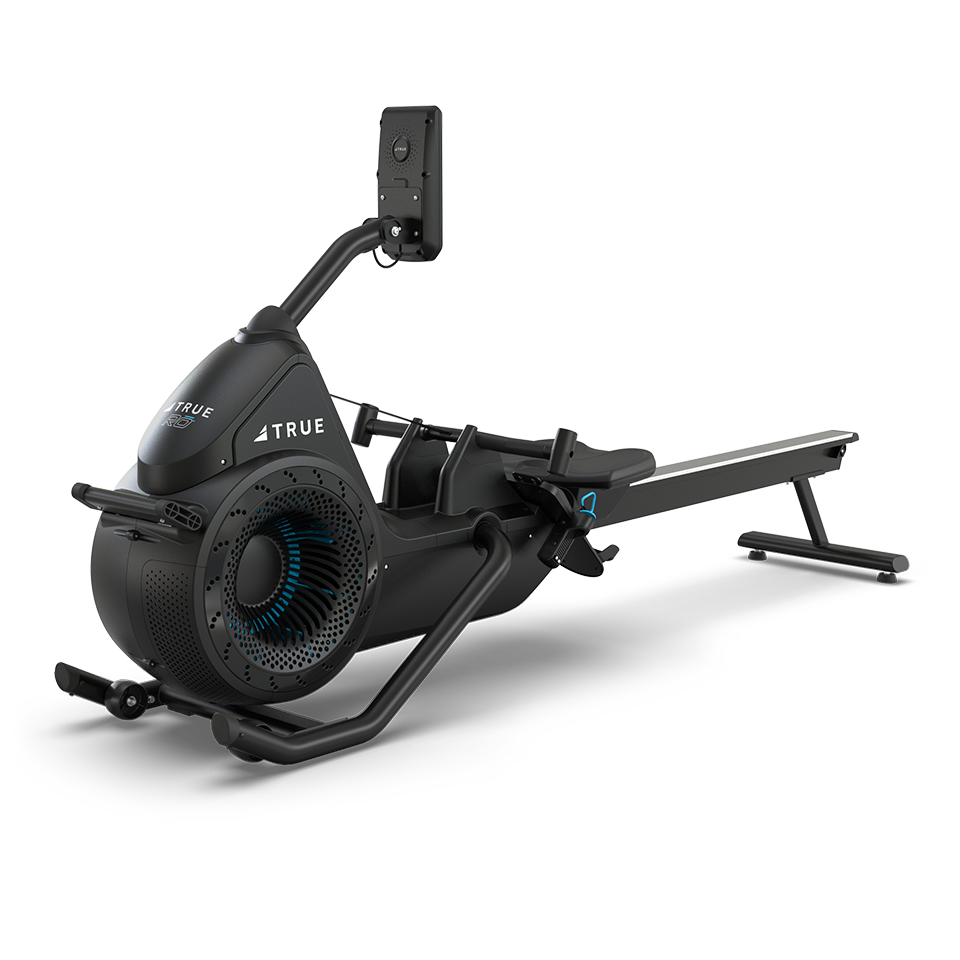 A black and sleek rowing machine with a digital monitor, sturdy frame, and footrests, displayed on a white background. The machine features the brand name TRUE on its side.