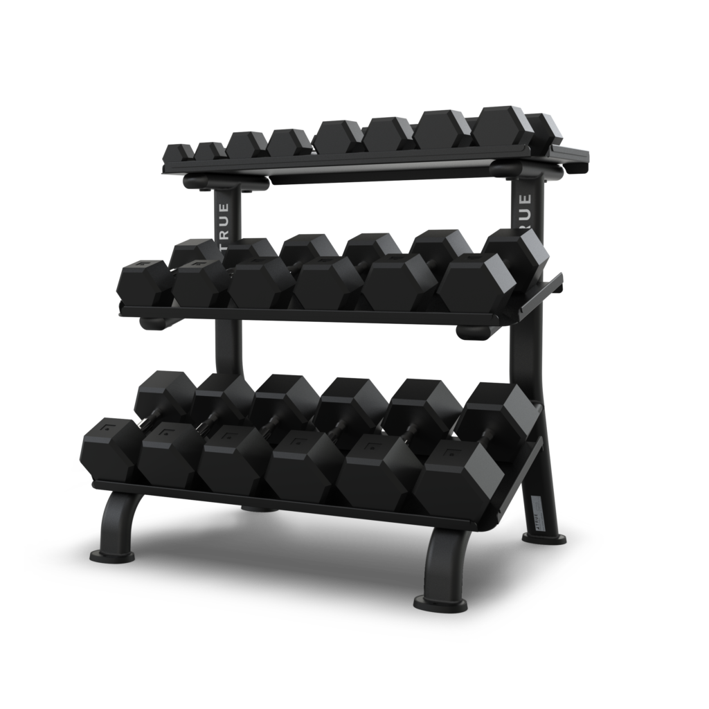 A three-tier black metal rack holds several pairs of black hexagonal dumbbells, arranged by weight, on a plain white background.