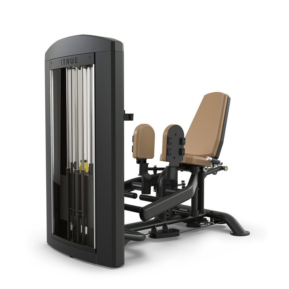 A seated gym machine with tan padding and a black frame, designed for leg exercises. It features an adjustable weight stack and padded, separable leg rests for targeting inner thigh muscles.