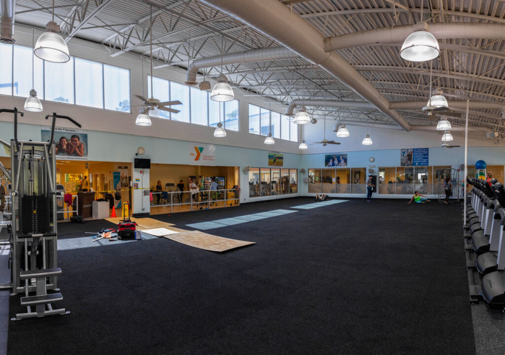 A large room with black carpet and lights.