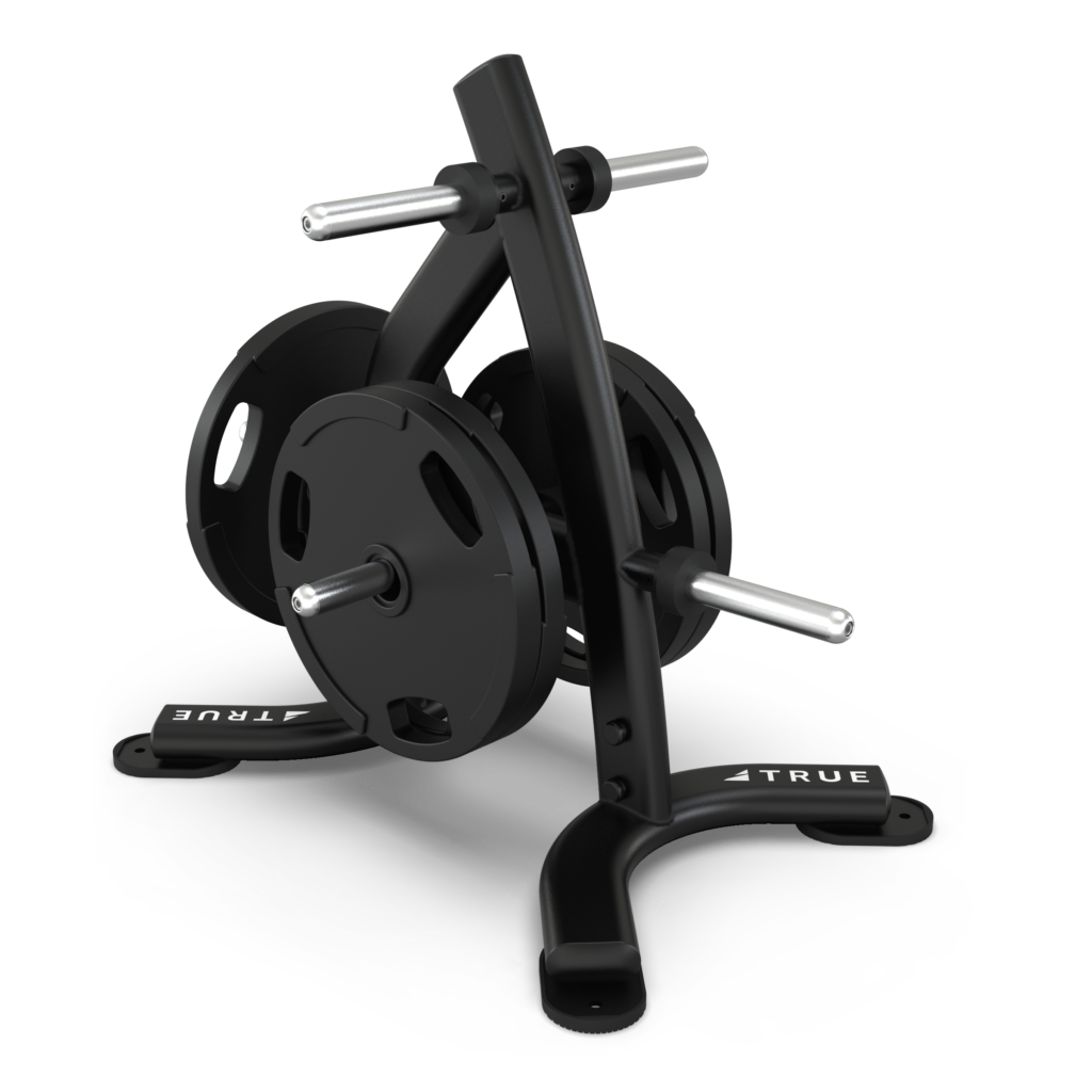 Black metal weight plate rack holding several round weight plates, with four horizontal arms for storage and a sturdy base labeled TRUE on both feet. The background is plain white.
