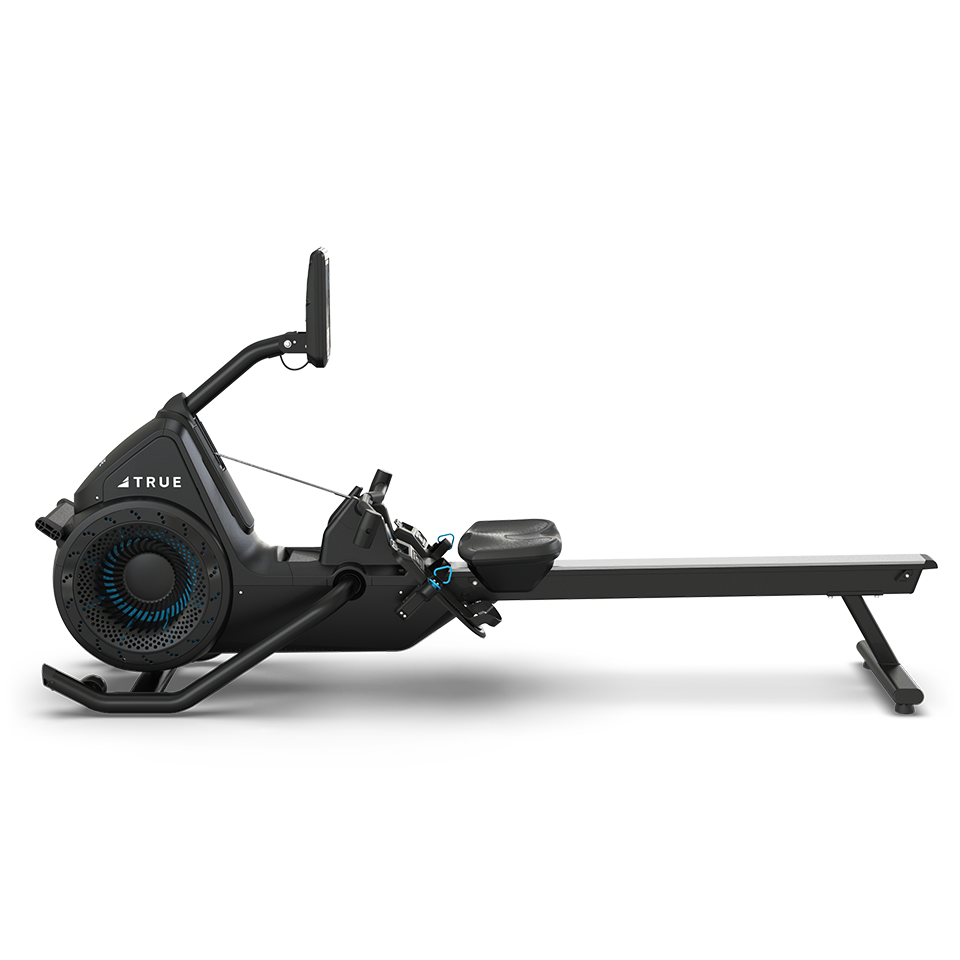 A black rowing machine with a digital display, footrests, and a long sliding seat, shown from the side against a plain white background.