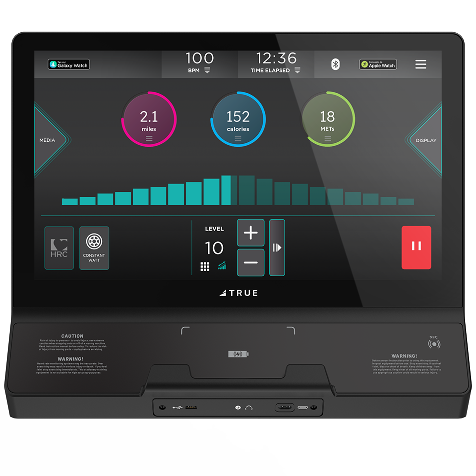 A treadmill display screen shows workout stats: heart rate 100 BPM, 12:36 time elapsed, 2.1 miles, 152 calories, 18 METs, and media controls. The console has various buttons and ports below the screen.