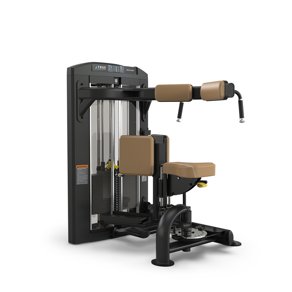 A black and tan gym machine with padded seats and arm supports, designed for abdominal and back exercises, featuring a weight stack and adjustment levers, positioned on a white background.