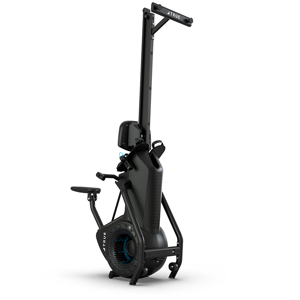 A black vertical ski exercise machine with handlebars, a fan flywheel at the base, and foot platforms, designed for indoor cardio workouts, against a plain white background.